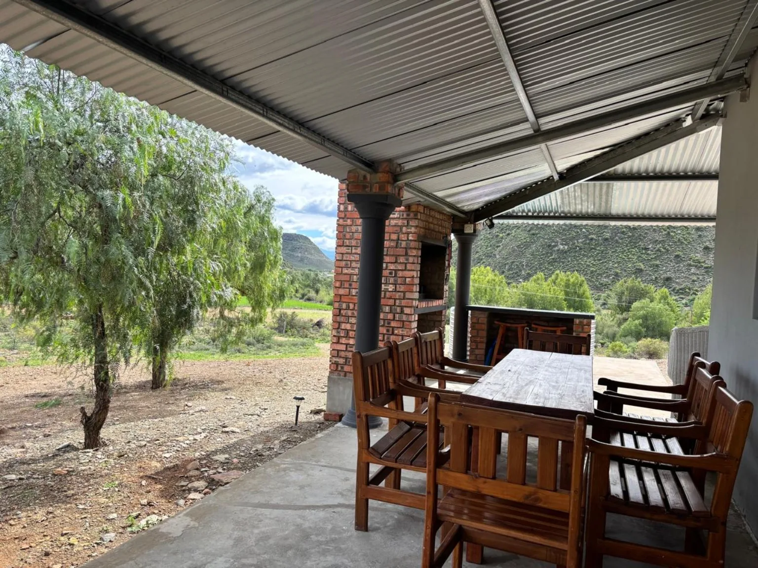 Covered veranda with six-seater outdoor dining table