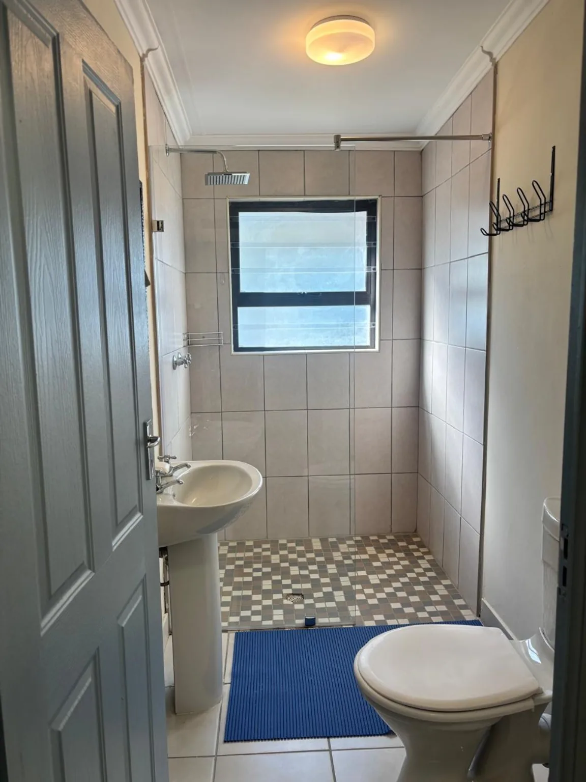 Bathroom with shower, basin and toilet