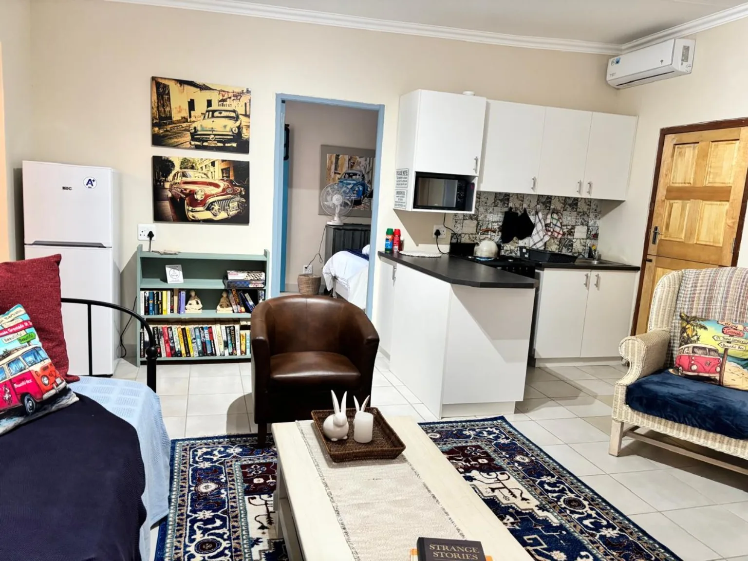 Open-plan kitchen and living area with wicker armchairs