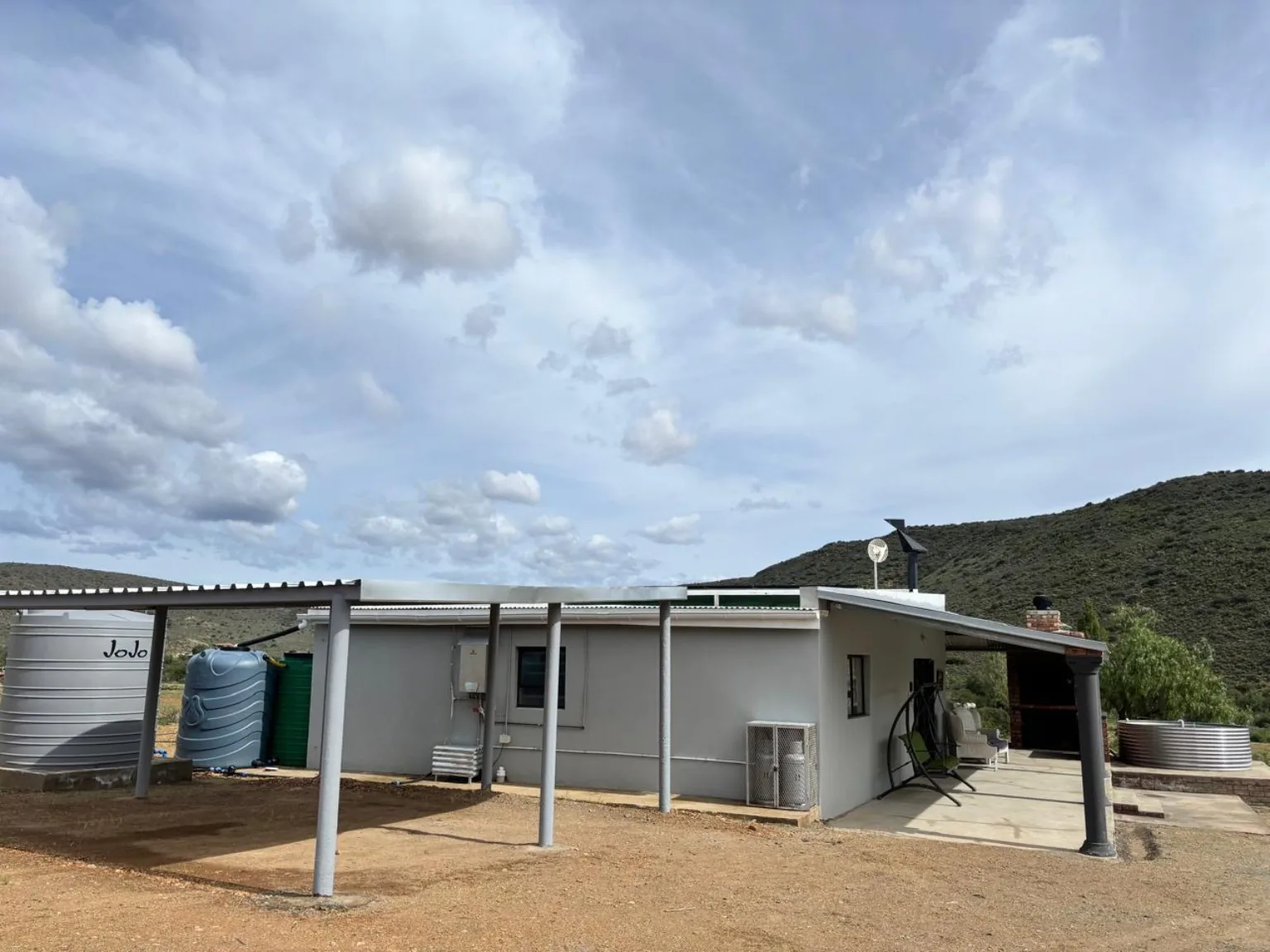 Wide view of the off-grid cottage and Klein Karoo hills