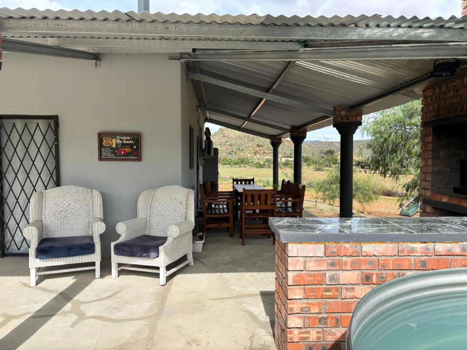 Veranda seating beside the built-in braai and splash pool
